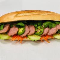 S7. Minced Pork Patty sandwich - Bánh mì nem nuớng · Thin slices of sweet and smoky flavored pork sausage
