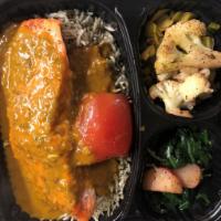Curried Salmon Filet · Atlantic Salmon, Basmati Rice cooked with dill and sauteed spinach with Jamaican Curry Sauce