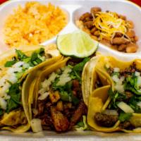 Taco Plate  · Choice of meat, 3 Tacos Rice and Beans.

Extra charge for extra salsas and lime. See Sides