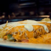 Suizas Enchiladas · Green sauce enchiladas  topped with melted cheese and sour cream. Served with rice and beans
