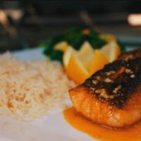 Salmon a la Parrilla · Grilled salmon with rice and vegetables. 