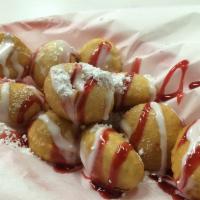 Berry Bites · Fresh dough bites flash fried and drizzled with raspberry and white chocolate then topped wi...