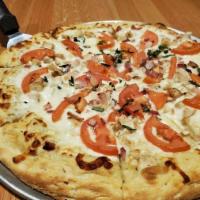 The Chicken Ranch Specialty Pizza · Grilled chicken, Roma tomatoes, basil, and rasher bacon with a ranch dressing sauce base.