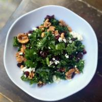 Kale Salad · Chopped Tuscan kale, candied walnuts, crasins, topped with an apple cider vinaigrette.