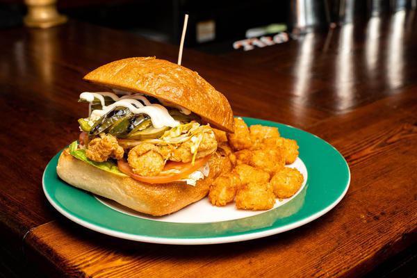 Fish Sandwich · Crispy Haddock, slaw, lettuce and tomato, grilled jalapeno, pickle, mayo on Ciabatta roll. Served with hand-cut fries or tater tots. 