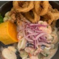 Ceviche Carretillero Mixto · Fresh seafood mix marinated in lime juice with aji limo and rocoto, garlic, cilantro, red on...
