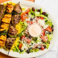 Kebab Combination · Chicken, lamb, and kafta kebabs served with a bed of basmati rice and Greek salad.