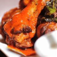Colossal Chicken Wings · Our giant crispy chicken wings, tossed with traditional spicy/ butter buffalo sauce served w...