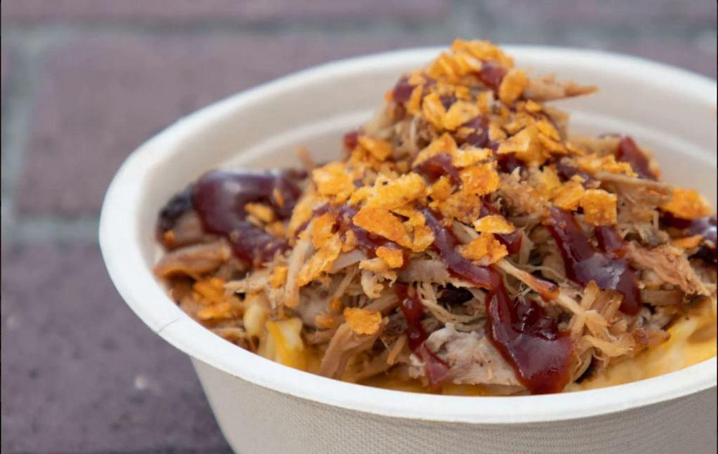 Piggy Mac · A big helpin of home made mac and cheese topped with pulled pork, tangy BBQ sauce and BBQ potato chips.