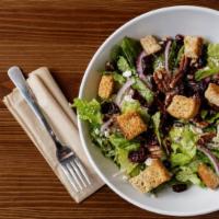 Chopped Signature · Romaine, onion, cranberries, feta, roasted pecans and croutons with chopped balsamic. Topped...