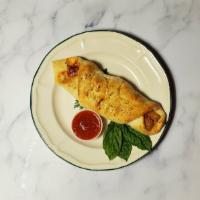 Chicken Roll · Chicken cutlets, marinara sauce, and mozzarella cheese rolled in our homemade dough topped w...