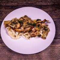 Nona's Favorite · Grilled chicken breasts topped with artichokes, mushrooms and lemon butter white wine sauce....