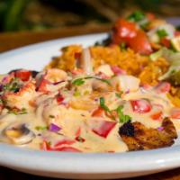 Acapulco Fish · Grilled tilapia fish smothered in our famous creamy wine sauce with sauteed shrimp and crawf...