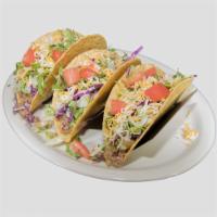 Crispy Tacos · 3 crispy corn tortillas with your choice of ground beef or shredded chicken. Dressed with cr...