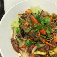 Thai Beef Salad · Grilled beef with cucumber, red onion, tomatoes, carrot, green onion and cilantro. Served wi...