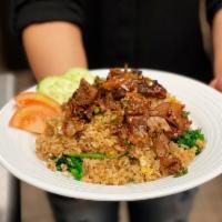 Duck Fried Rice · Fried rice with egg, duck meat, tomatoes, Chinese broccoli, white onion and green onion.