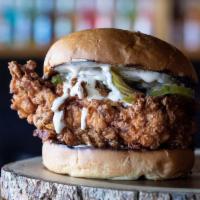 Crispy Chicken Sandwich · Buttermilk fried chicken breast topped with pickles and served with Alabama white sauce.