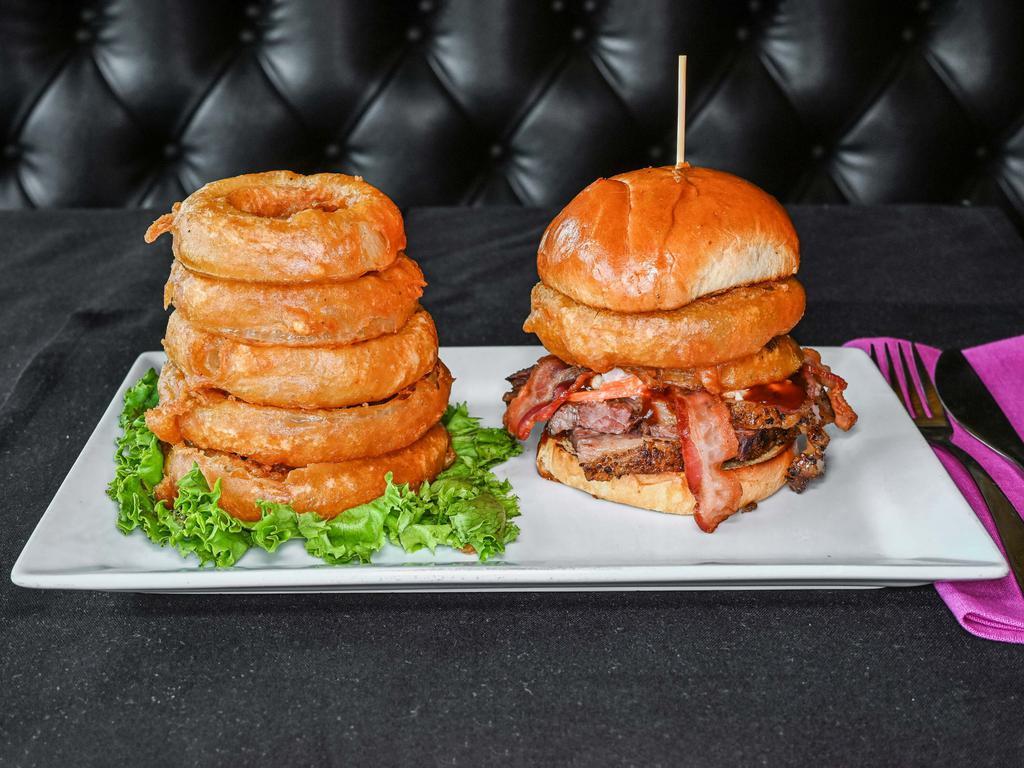 Tennessee Smokehouse Sandwich · Mouthwatering house-smoked brisket, house-made bourbon BBQ sauce, bacon, coleslaw, and an onion ring on a brioche bun.