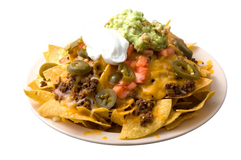 Nachos · Corn tortilla chips topped with beans, cheese, choice of meat, pico de gallo, guacamole, and sour cream.
