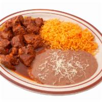 Birria Plate · Slow cooked beef chunks topped in red sauce served with rice, beans, and tortillas.