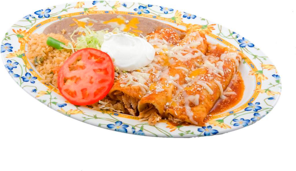 Enchilada Plate · 3 enchiladas in red sauce stuffed with choice of meat and topped with melted cheese, sour cream, lettuce and tomato. Sefved with rice and beans.