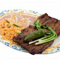 Carne Asada Plate · Grilled steak served with rice, beans, and tortillas. and small salad, with Tausan Italian o...
