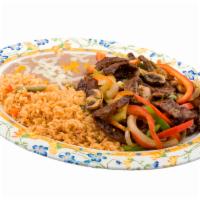 Steak Fajita Plate · Grilled steak with sauteed peppers, onions, and mushrooms. Served with rice, beans, and tort...