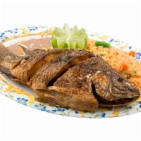 Mojarra Plate · Fried Whole Tilapia served with rice, beans, and tortillas.