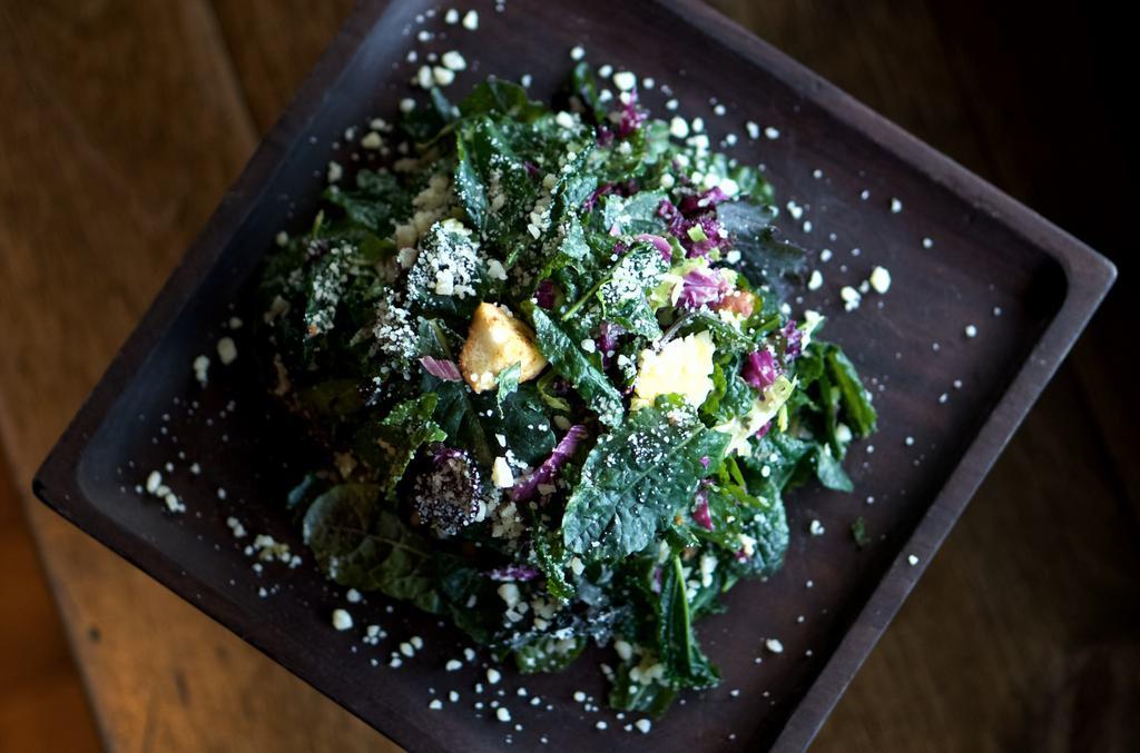 Kale Caesar Salad · Shaved brussels sprouts, Grana Padana, and pretzel croutons.