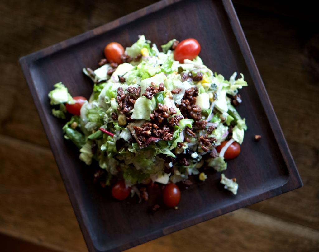 Chopped Salad · Grilled corn, red onion,apple, bleu cheese, cherry tomatoes, candied pecan, and champagne vinaigrette.
