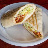 Turkey Club Wrap · Oven roasted turkey breast topped with shredded lettuce, tomato and smoked bacon served with...