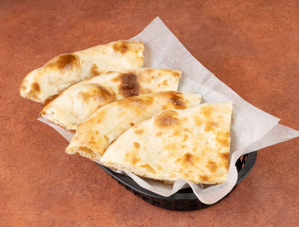 Naan · Round shaped flat bread baked in tandoor (clay oven).