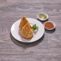 Spinach Samosa · Fried triangular dough stuffed with spinach, potato, green peas and cilantro seeds. Served w...