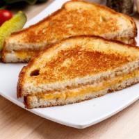 Grilled Cheese Sandwich · With American, Swiss and cheddar on a white slice. Served with your choice of side and a pic...