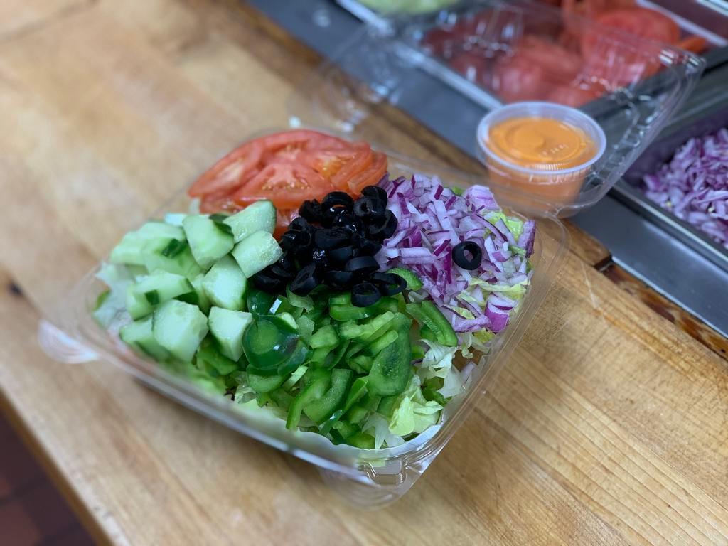 Garden Salad · Green Salad w/ Cuccumbers, Tomatoes, Green Peppers, Onions, & Black Olives.  Served with a side of our homemade croutons.