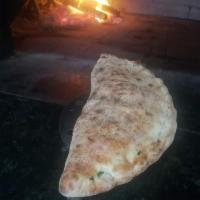Calzone Verde · Mozzarella, spinach, black olives and Parmesan cheese.