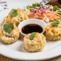 Thai Dumpling · 4 dumplings made with chicken, shrimp, mushrooms, and water chestnuts served with a soy vine...