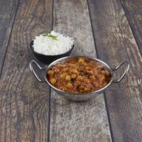 Chana Masala · Garbanzo beans cooked with onion, ginger, garlic and tomato in a spicy sauce. Served with ba...