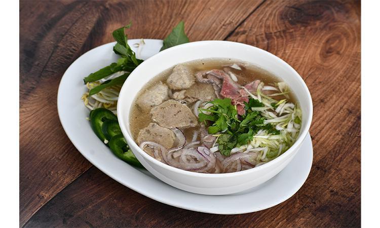Large Beef Pho Soup with Meatballs Dinner · Rice noodles, sliced beef brisket, onions, bean sprouts, Thai basil, scallions, cilantro, jalapenos, lime, fresh homemade beef broth, hoisin, and Sriracha. Spicy.