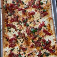 Grandma Pizza Slice · Square slice with mozzarella cheese, garlic, plum tomato and basil. A house favorite!