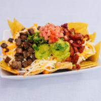 BBQ Nachos · Tortillas chips topped with Texas caviar and Monterey Jack and cheddar cheese. Served with s...