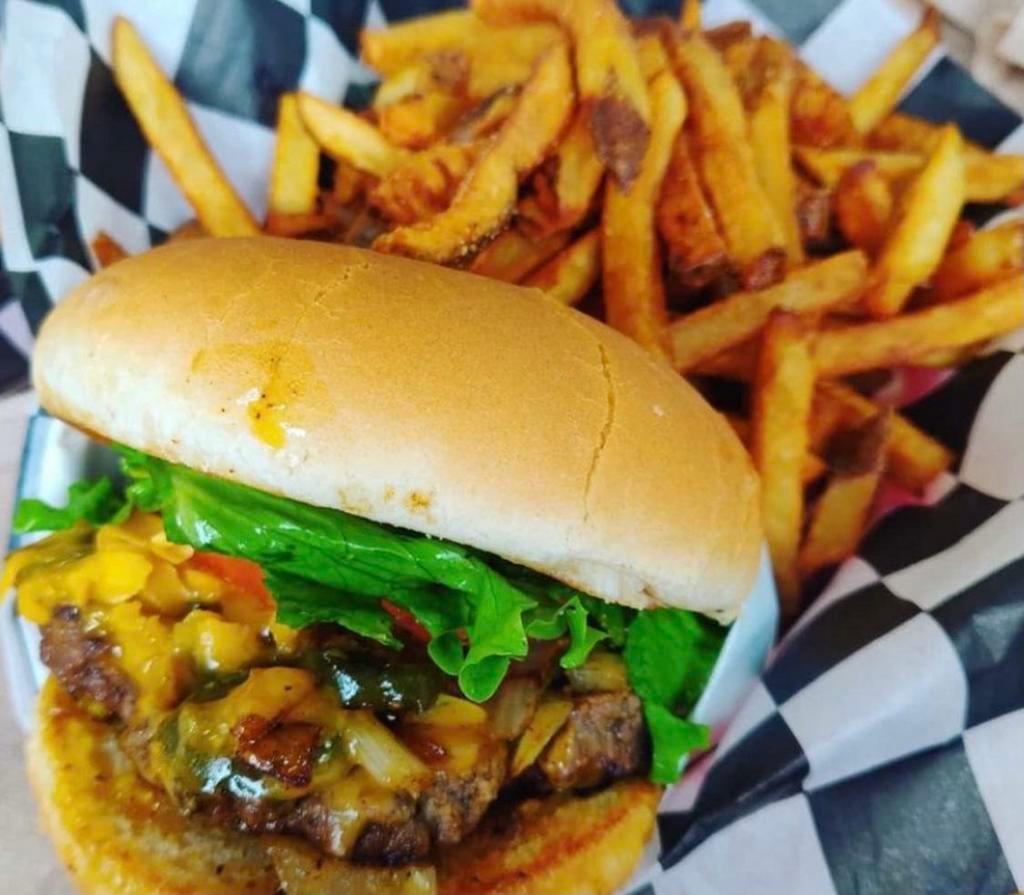 #7. Project X and Fries · Tabasco sauce cooked in to the meat, grilled onions and jalapenos topped off with cheddar cheese, mustard, pickles, lettuce and tomato.