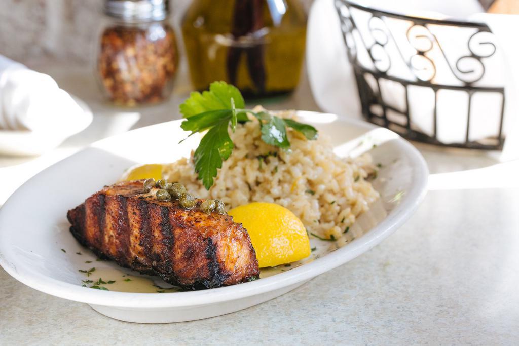 Atlantic Salmon · Simply grilled topped with lemon, olive oil, and capers served with mushroom risotto.