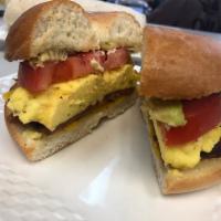 Egg, Tomato, Cheddar and Avocado Bagel Breakfast · Scrambled eggs, tomato and cheddar on grilled plain bagel with guacamole on the side.