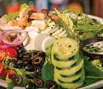 Cobb Salad · Grilled chicken, tomatoes, avocado, bacon, red onions, cucumbers, black olives, feta and an egg on a bed of romaine with bleu cheese or ranch.