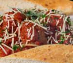 Schpaghetti and Meatball · A bed of our spaghetti topped with tomato sauce, juicy meatballs and Parmesan cheese - or ch...