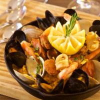 Paella Sevillana · Spanish rice, chorizo, clams, mussels, calamari, shrimp, roasted tomatoes, peppers and saffr...