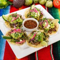Tacos Perrones  · Five 4” double-stacked corn tortillas filled with steak, topped with guacamole, nopales, que...
