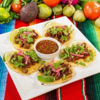 Tacos Chilangos · 4” double-stacked corn tortillas with melted cheese in the middle and filled with steak and ...