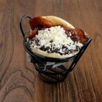 Orinoco Arepa (V) · Grilled corn dough patty (arepa) filled with black beans, sweet plantains, and grated white ...